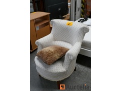 Wooden armchair with sitting in white speckled fabric and pillow